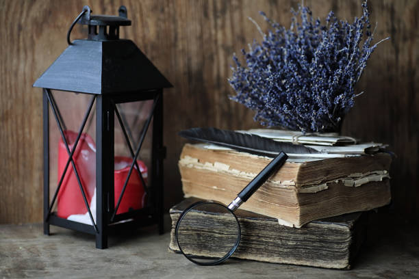 istock Old books on a wooden table and magnifier 859117634