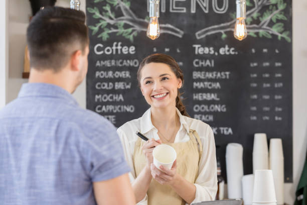 istock Beautiful young coffee shop employee flirts with customer 859123372