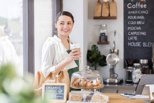 istock Beautiful coffee shop employee enjoys coffee break 859123416