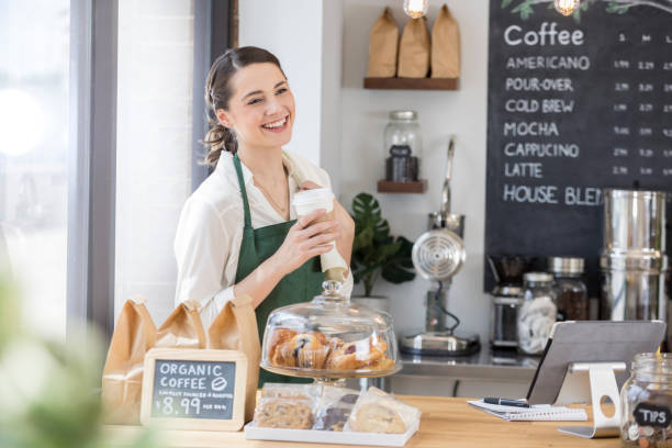 istock Young coffee shop waitress enjoys coffee break 859123418