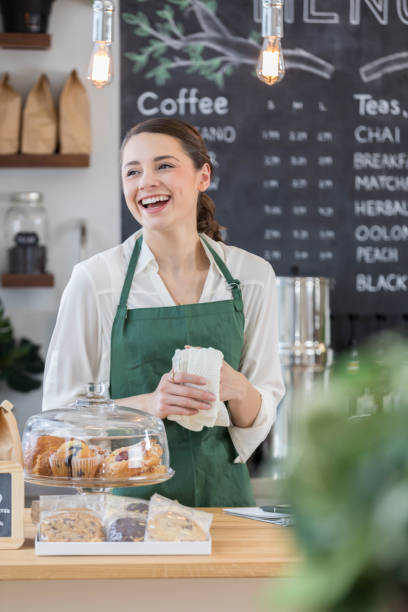 istock Young woman enjoys working in her coffee shop 859123420