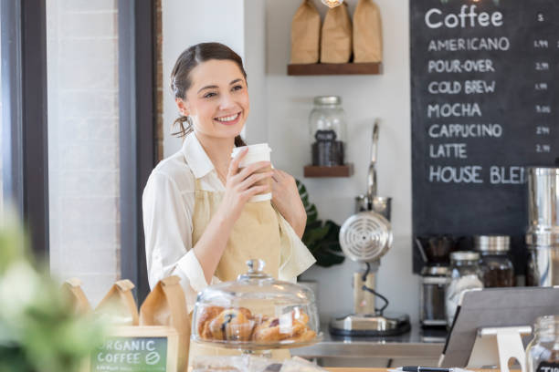 istock Cheerful coffee shop owner enjoys morning coffee before customers 859123422