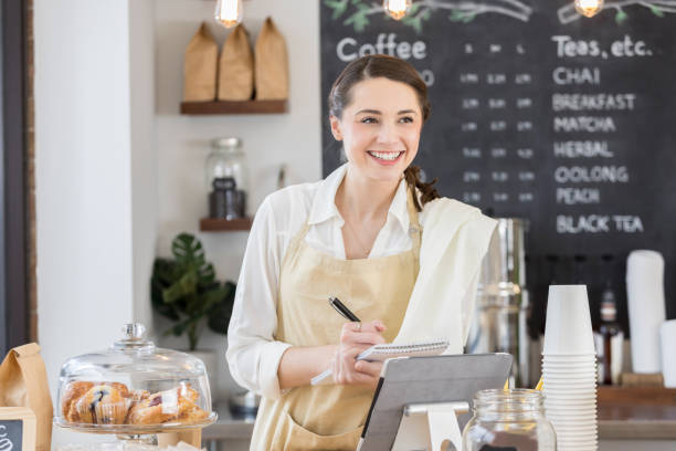 istock Beautiful young coffee shop employee takes order 859123426