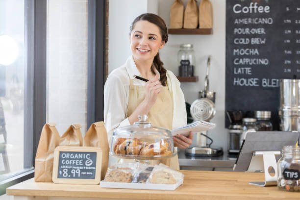 istock Thoughtful female barista writes in order pad 859123482