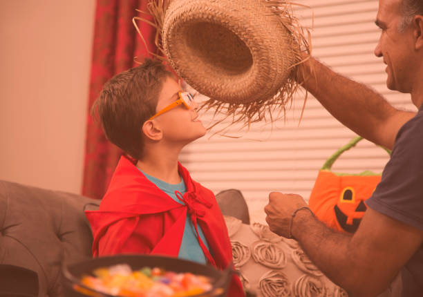 istock Little boy dresses up for Halloween with dad's help. 859125662