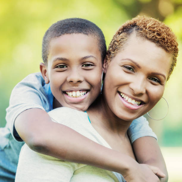 istock Portrait of tween boy embracing his mom 859125764