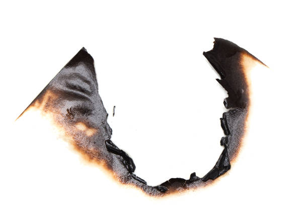 istock burnt hole in a paper 859129234