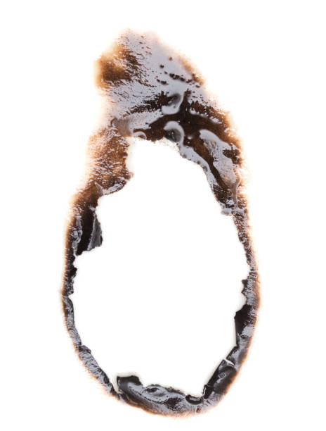 istock burnt hole in a paper 859129466