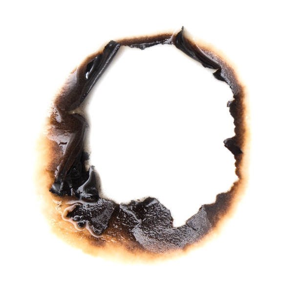 istock burnt hole in a paper 859129496