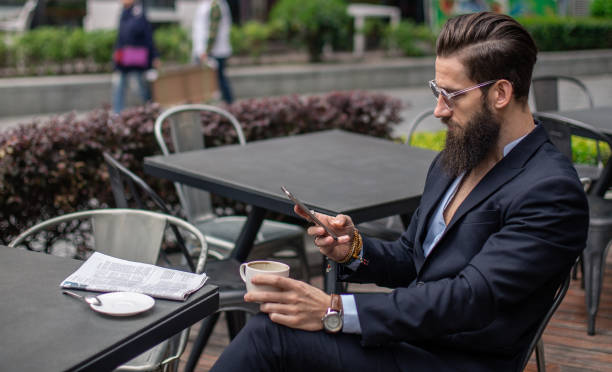 istock Urban man sitting in cafe and texting 859129862