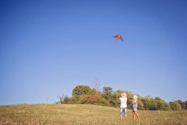 istock Young couple flying kite in nature 859133186