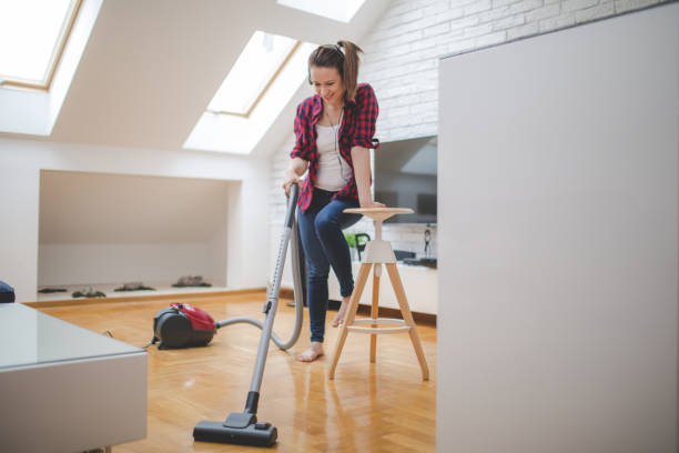 istock Young woman cleaning home 859135682