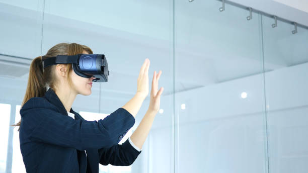 istock Woman Wearing virtual reality glasses in Office, using VR goggles headset 859139592