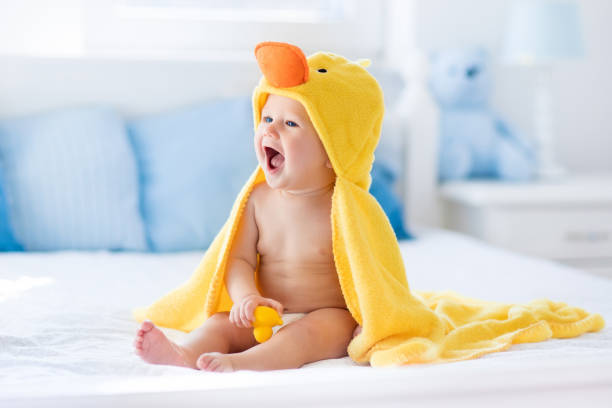 istock Cute baby after bath in yellow duck towel 859143272