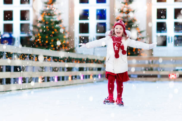 Kids ice skating in winter. Ice skates for child. Kids ice skating in winter park rink. Children ice skate on Christmas fair. Little girl with skates on cold snowy day. Snow outdoor fun for child. Winter sports. Xmas vacation activity with kid. ice skating photos stock pictures, royalty-free photos & images