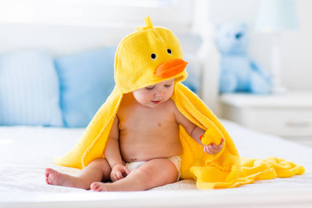 istock Cute baby after bath in yellow duck towel 859143692