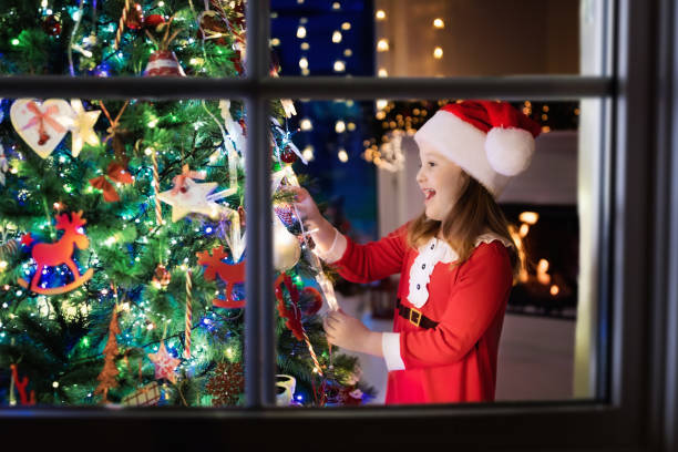 istock Child at Christmas tree and fireplace on Xmas eve 859143746