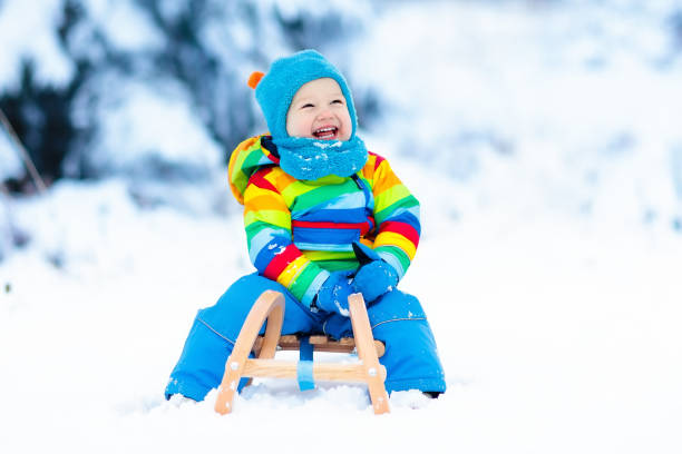 istock Boy on sleigh ride. Child sledding. Kid with sledge 859156508