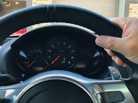 shot of a hand on steering wheel