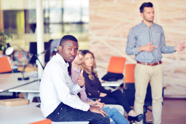 istock business, startup, presentation, strategy and people concept - man on presentation with group of people at office 859156792