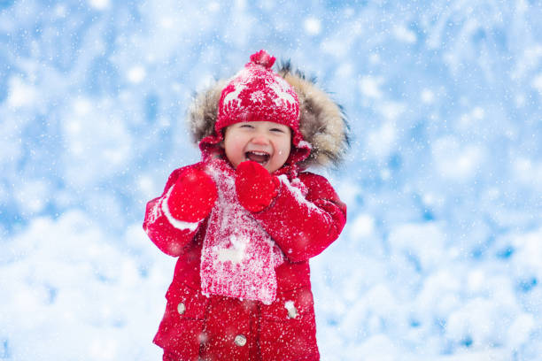 istock Baby playing with snow in winter. 859161504