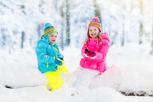 istock Kids playing in snow. Children play outdoors in winter snowfall. 859161730
