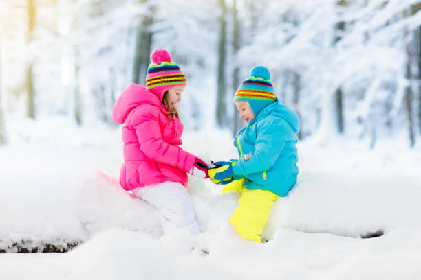 istock Kids playing in snow. Children play outdoors in winter snowfall. 859163594