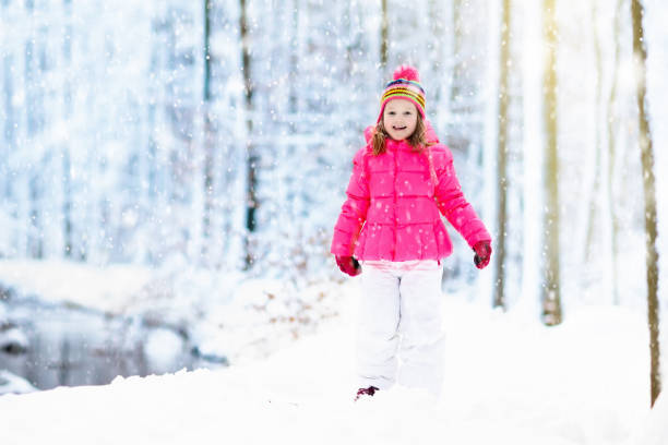 child playing with snow in winter. kids outdoors. - 13603 imagens e fotografias de stock