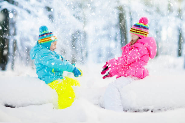istock Kids playing in snow. Children play outdoors in winter snowfall. 859164140