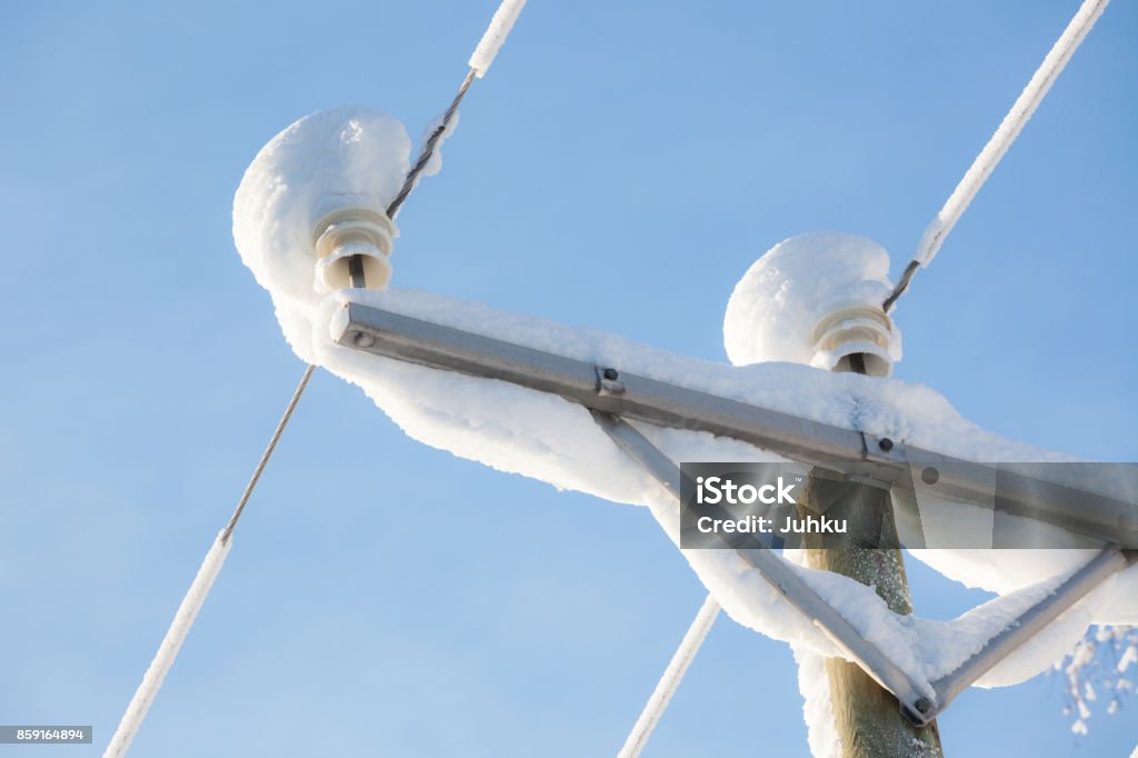 Snow covered power lines closeup Snow covered power lines closeup and sky Power Line Stock Photo