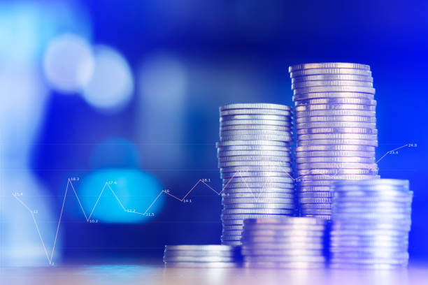 istock Double exposure Stacks of coins on working table with financial graph chart, finance and business concept, 859167364