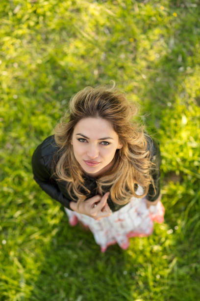 istock Smiling woman standing outdoors in nature, she is looking at camera, top view 859176804