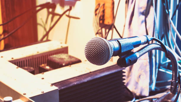 istock Microphone on a stand with audio mixer in the control room audio system. 859177498