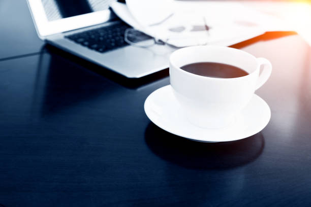 istock Coffee cup and office supplies on table 859186154