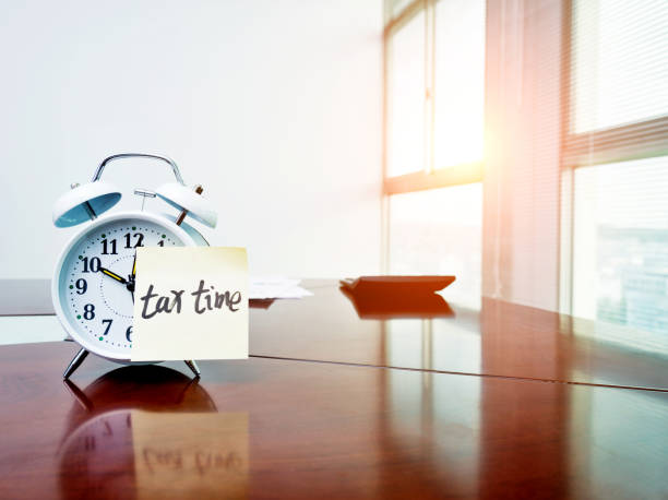 istock A clock with tax time sticky note and calculator on the desk 859186398
