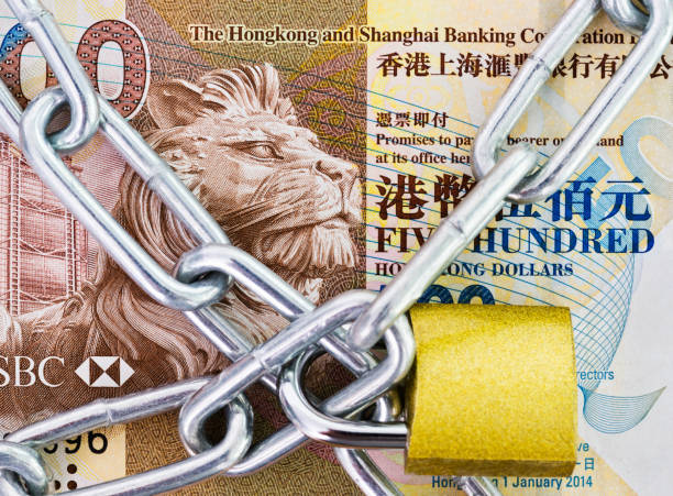 Hong Kong currency with a chain and lock Hong Kong currency with a chain and lock. bills lions stock pictures, royalty-free photos & images