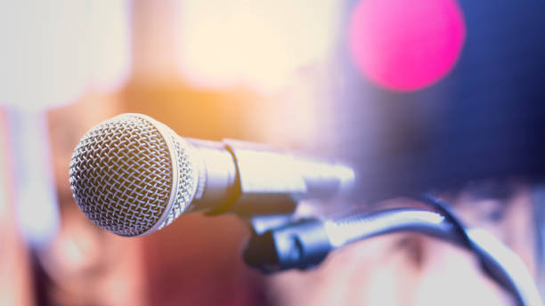 istock Microphone on a stand with audio mixer in the control room audio system. 859189998