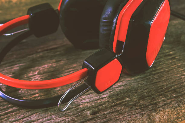 istock Red earphones with very old wood. 859192152