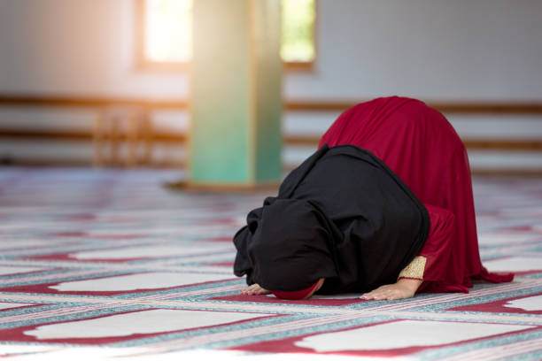 istock Young muslim woman praying in mosque 859193080
