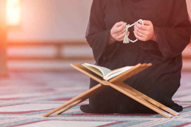 istock Young muslim woman praying in mosque 859195502