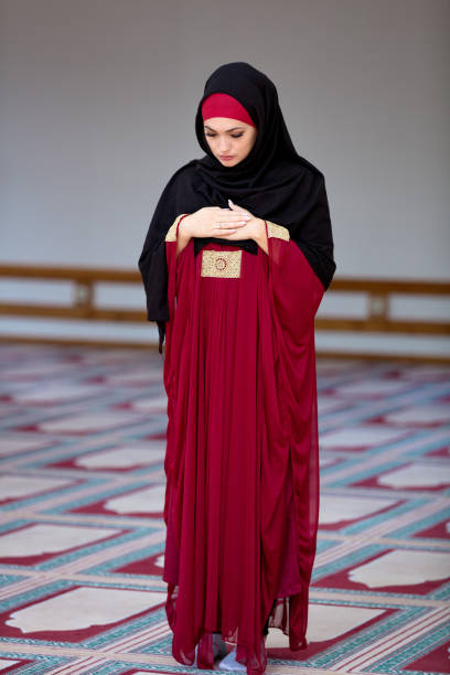 istock Young muslim woman praying in mosque 859195584