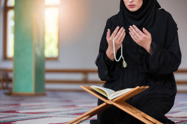 istock Young muslim woman praying in mosque 859195632