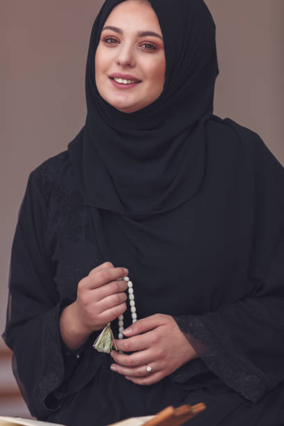 istock Young muslim woman praying in mosque 859195720