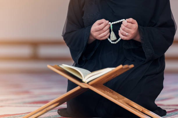 istock Young muslim woman praying in mosque 859195800