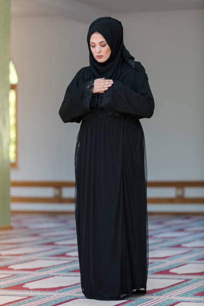 istock Young muslim woman praying in mosque 859196336