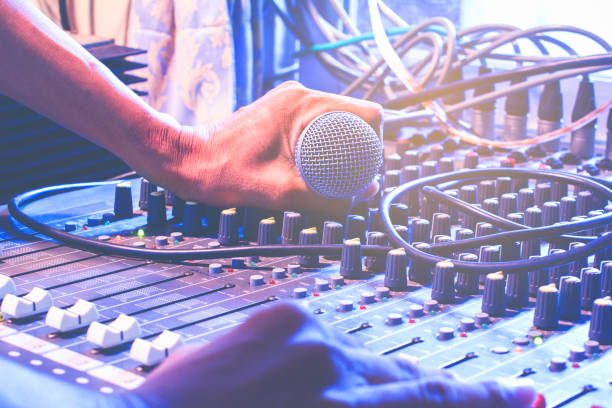istock Man's hands control the sound. The microphone and the audio mixer. 859198562