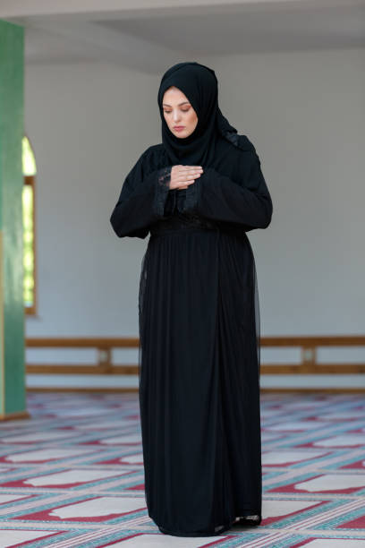istock Young muslim woman praying in mosque 859198568