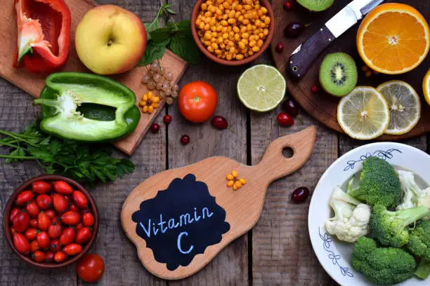Composition of products containing ascorbic acid, vitamin C - citrus, cauliflower, broccoli, sweet pepper, kiwi, dog rose, tomatoes, apple, currant, sea buckthorn. Top view. Flat lay. Healthy food.
