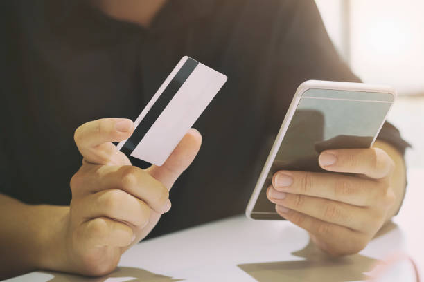 istock Hands holding credit card and entering security code using smart phone online shopping concept. 859233328