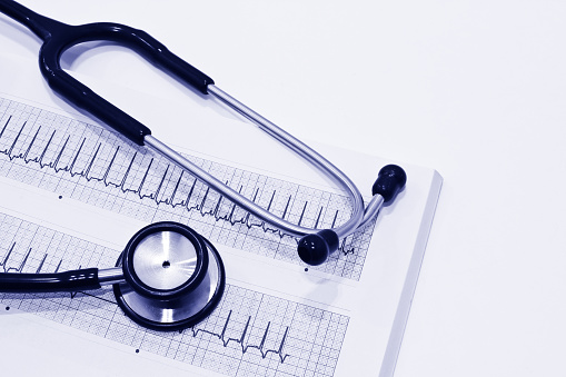 Stethoscope and Electrocardiography (ECG or EKG) Isolated on the White Background
